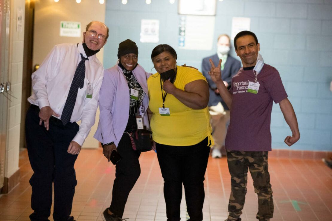 Four people smiling