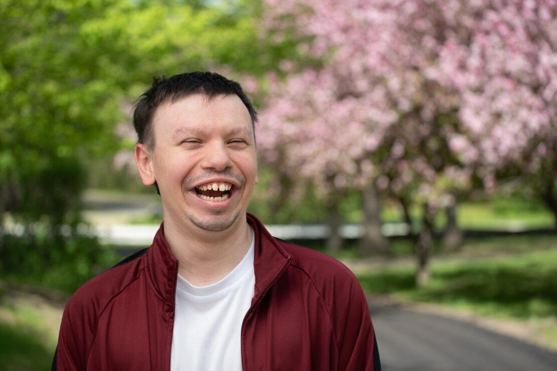 Man in red jacket smiling