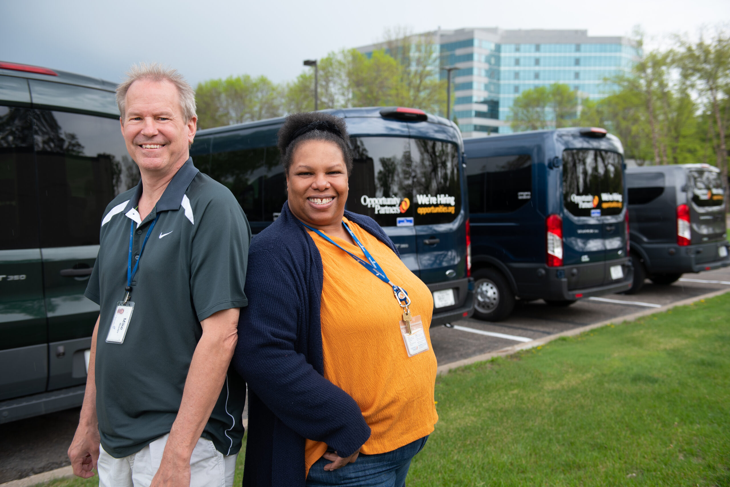 Man and woman standing near vans