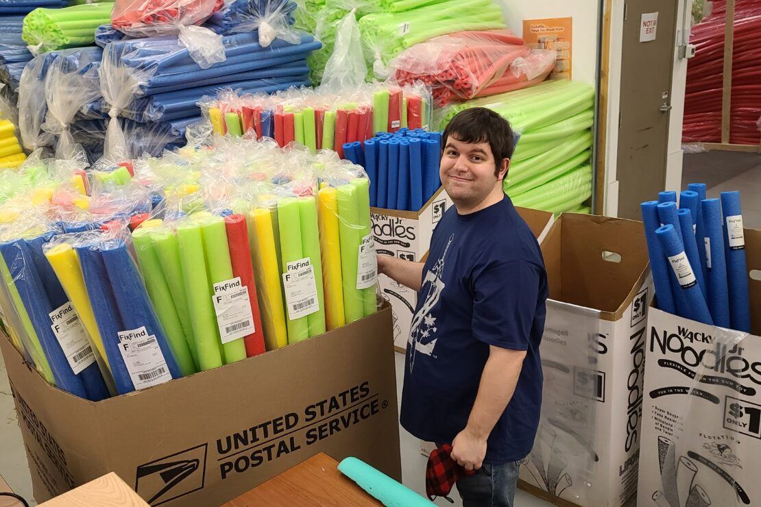 Man surround by pool noodles at work