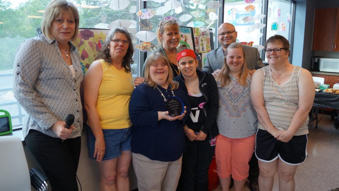 Group of people holding an award