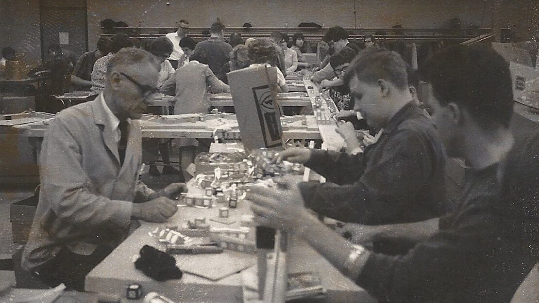 black and white photo of people working on production