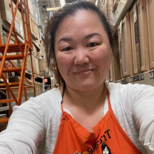 Woman smiling for a selfie in a Home Depot