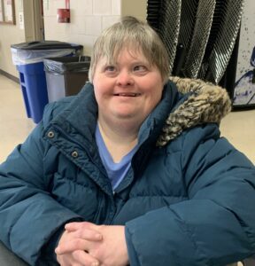 Woman in a blue winter coat smiling