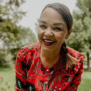 Woman in a red floral shirt smiling