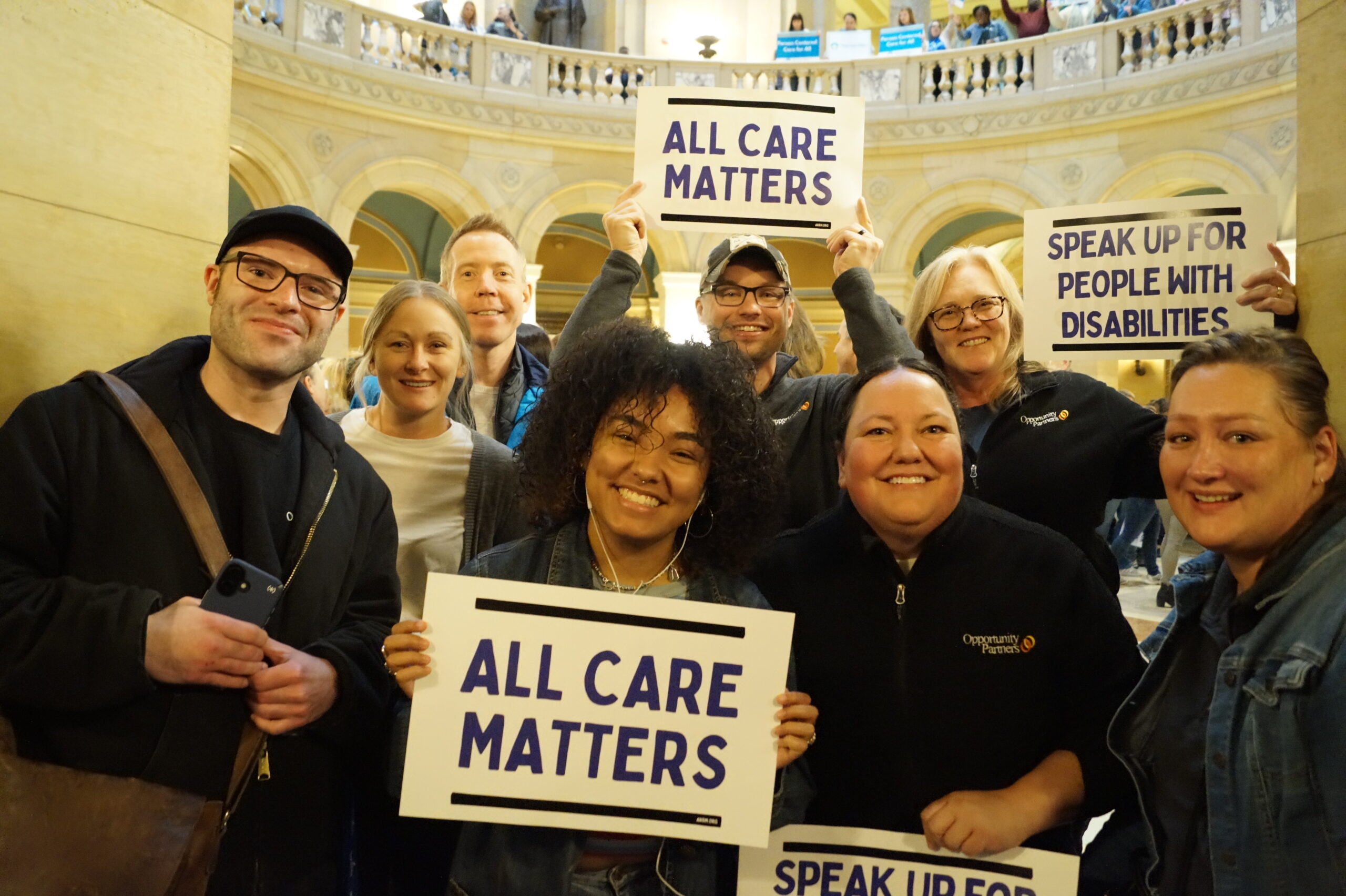 A group of people holding signs that say 