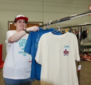 Woman hanging clothes on a rack.