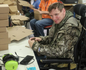Man in wheel chair working in warehouse
